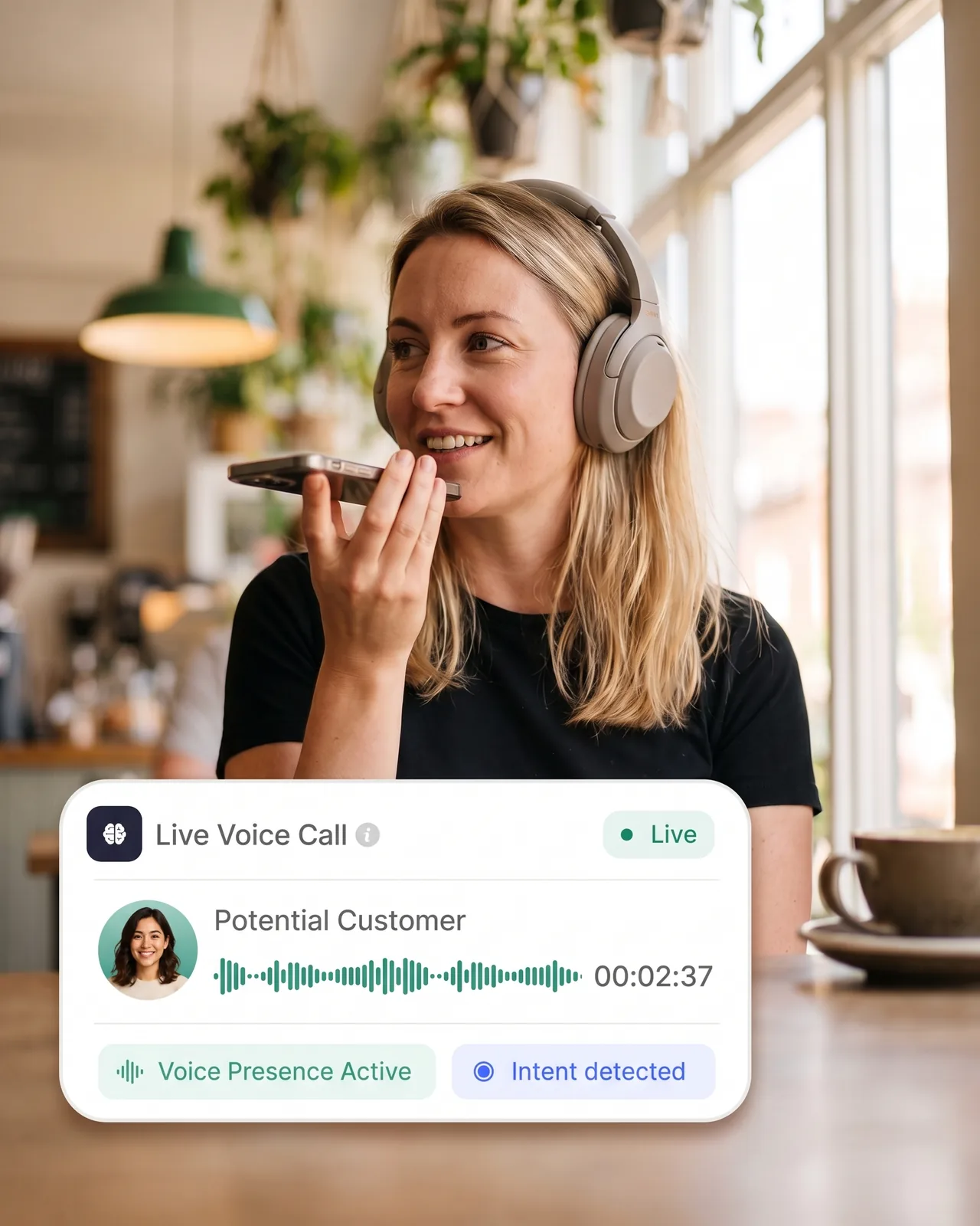 Someone on a call in a cafe, speaking into their phone on speaker.